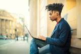 Person using moto buds charge while on laptop