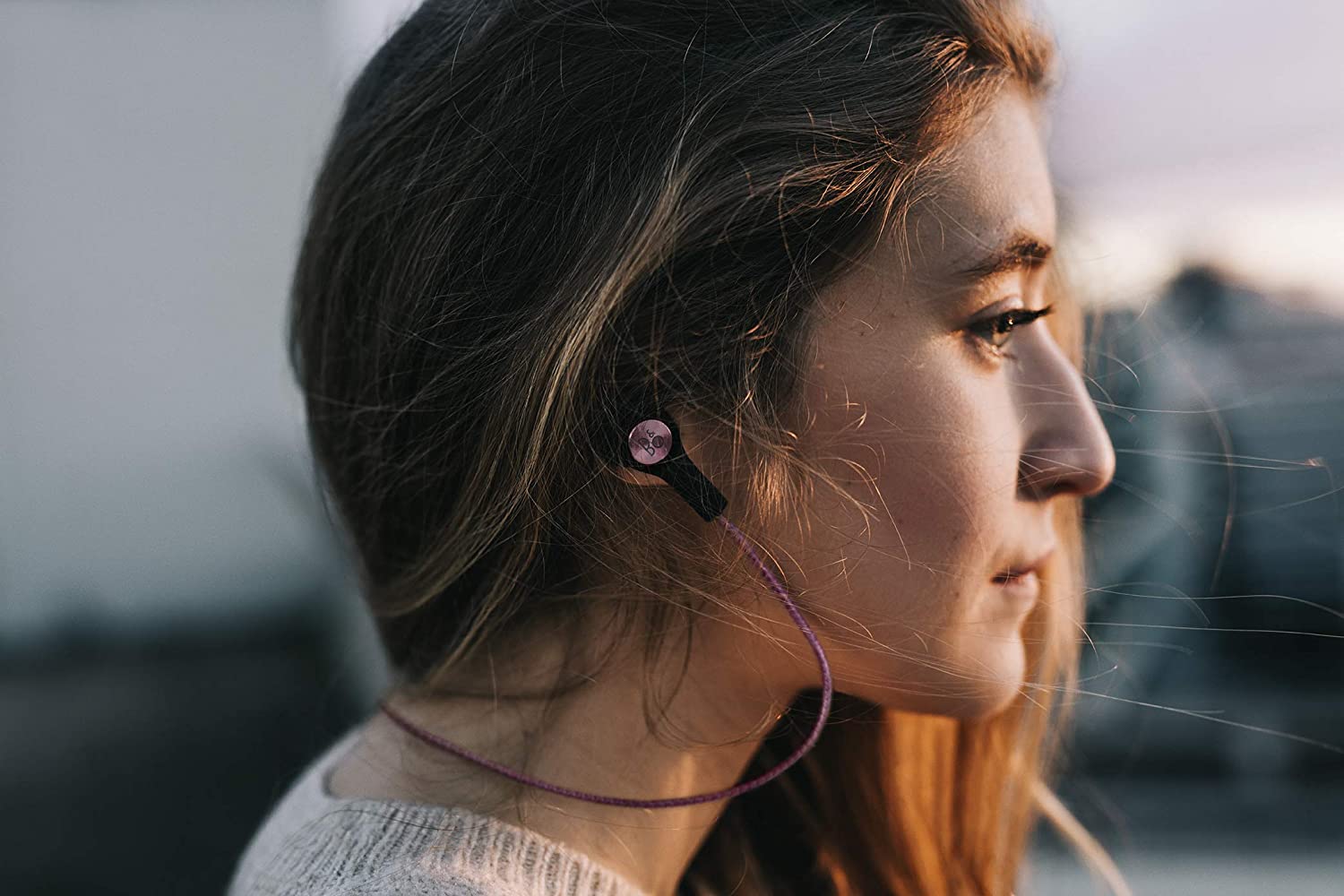 Bang & Olufsen Beoplay H5 Splash and Dust Proof Wireless Earphones rose ear buds on woman